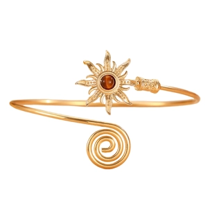 Detailed view of vintage gold sun arm cuff featuring brown gemstone and spiral texture