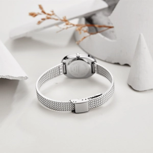 Detail of silver stainless steel mesh strap and case back on minimalist oval watch