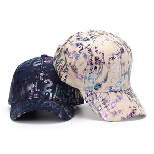 Navy and beige baseball caps with abstract graffiti prints and classic curved brims