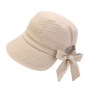 Detailed view of beige sun hat featuring 3D bubble texture and a large elegant bow