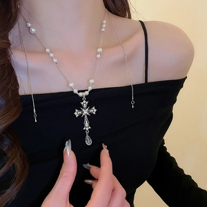 Detail of Gothic pearl necklace with crystal encrusted cross and water drop pendant