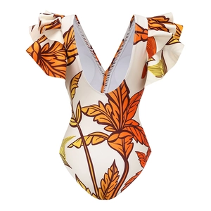 Detail of deep V-neckline on women's one-piece swimsuit with tropical leaf print and ruffles