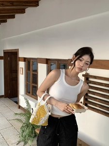 Detail of yellow and white hand-woven cotton rope bag with a modern hollowed-out texture