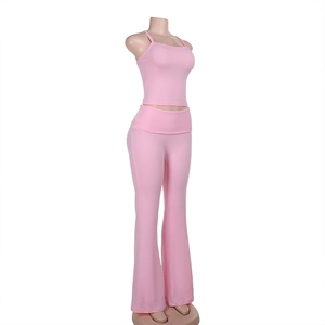 Side view of pink yoga set with cropped camisole top and high-waisted flared trousers