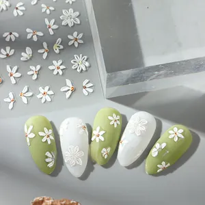 Detailed close-up of 5D embossed white daisy nail stickers with 3D floral textures