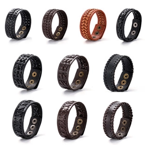 Macro display of woven leather bracelets with metal snaps in black and brown colors