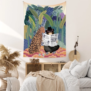 Detail of bohemian tapestry featuring surrealist woman and leopard in cozy bedroom decor