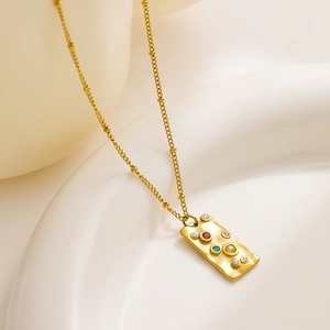 Macro shot of 18k gold plated rectangle pendant necklace with colorful zircon stones