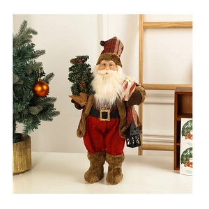 Standing Santa Claus doll in red plaid outfit with miniature tree and lantern decor