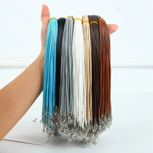 Macro shot of colorful braided necklace cords with silver lobster clasps in various shades