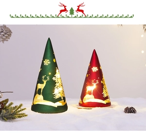 Close-up of frosted glass cone Christmas lights with hollow reindeer and forest patterns