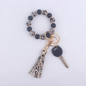 Detail of leopard print silicone beads and tassel keychain with rhinestone accents