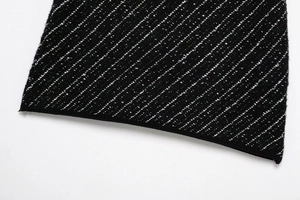Close-up detail of the black tweed knit fabric with white texture for women's two-piece set