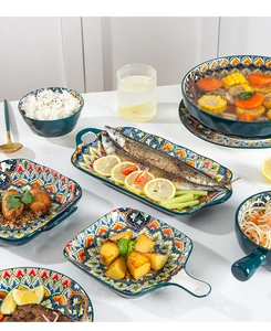 Detail view of Bohemian ceramic tableware set with colorful patterns on white table