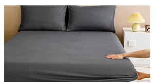 Close-up of elastic dark gray fitted sheet showing stretch fabric and smooth texture