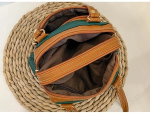 Top view of dual-compartment interior with zippers in green and brown patchwork handbag