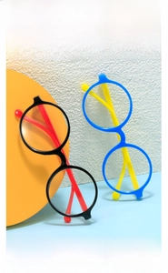 Close-up of stylish round kids glasses frames in black-red and blue-yellow color combinations
