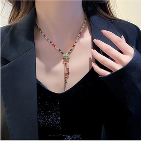 Detailed close-up of a luxury gold plated Y-shaped necklace with colorful zircon stones