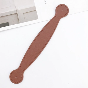 Detailed view of caramel Saffiano leather strap with fine stitching and round punched ends