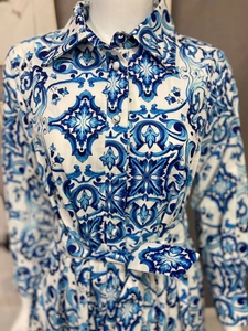 Detail of blue and white tile print dress with lapel collar and waist tie belt