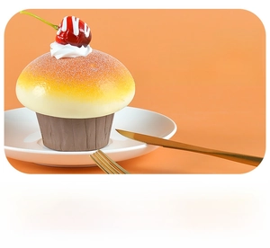 Realistic faux PU cupcake model with yellow top and red cherry detail on white tray