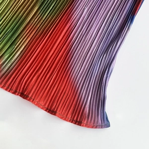 Detailed macro view of vibrant rainbow gradient pleated fabric with professional stitching
