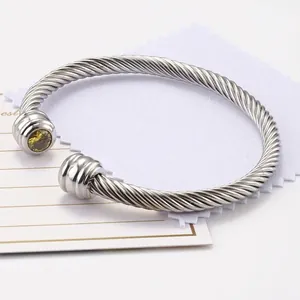 Silver twisted cable cuff bracelet with yellow zircon stone and stainless steel texture