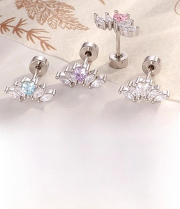 Macro detail of heart zircon studs showing titanium steel posts and size specifications