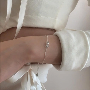 Minimalist 925 sterling silver bow bracelet featuring a delicate adjustable chain for women