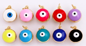 Detailed view of ten colorful enamel evil eye charms with gold metal edges