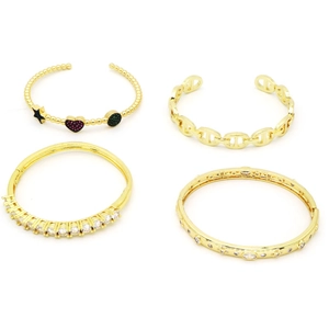 Macro shot of gold-plated pig nose link bracelets and zircon heart bangles in studio light
