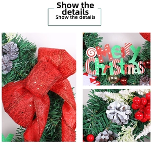 Detail of pine needle wreath with red bow, Merry Christmas sign, and pine cones