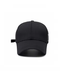 Front view of black cotton baseball cap with white cross embroidery and curved brim
