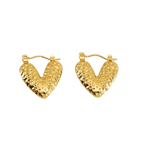 Close-up of golden hammered texture on heart-shaped hoop earrings for women