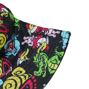 Close-up of colorful dinosaur graffiti print on black twill fabric fisherman hat