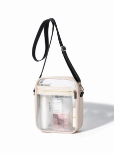 Detail view of transparent waterproof PVC shoulder bag with white trim and adjustable strap