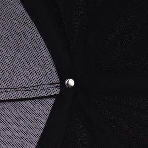 Macro detail of breathable black mesh interior and silver rivet on baseball cap crown
