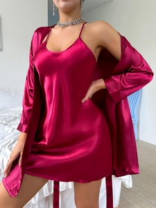 Detail view of burgundy satin nightgown set showing silk texture and lace trim