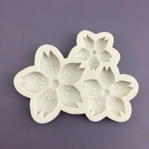White silicone cherry blossom mold with three flower cavities for cake decoration