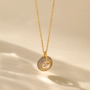 Detailed close-up of 18K gold-plated necklace with sparkling dancing zircon pendant