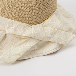 Women's summer straw sun hat featuring a wide brim with an elegant pleated cream bow