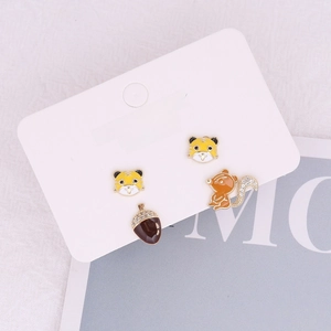 Detail of tiger and squirrel stud earrings set with 925 silver needles on jewelry card