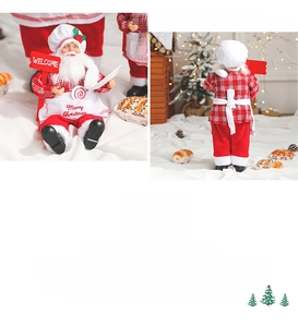 Detail of chef Santa Claus doll with red apron, welcome sign and knitting texture