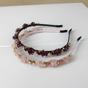 Close-up of two handmade crystal headbands with gold metal claw settings and non-slip pads