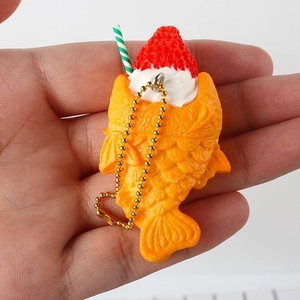 Realistic Taiyaki food keychain featuring cream and strawberry toppings on a gold bead chain