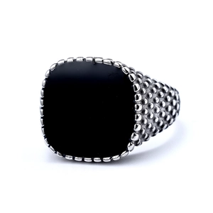 Men's vintage stainless steel ring with square black stone inlay on white background