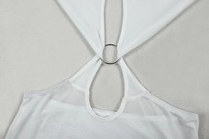 Macro shot of white mesh fabric texture with silver metal ring and cutout chest detail