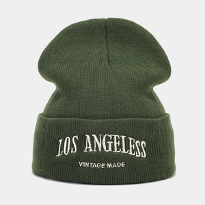 Detailed view of dark green knit beanie with white Los Angeles vintage embroidery