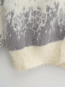 Macro view of grey and beige patchwork knitwear with soft fluffy texture and ribbed hem
