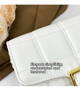 Close-up of white quilted leather texture with square stitching and gold metal buckle